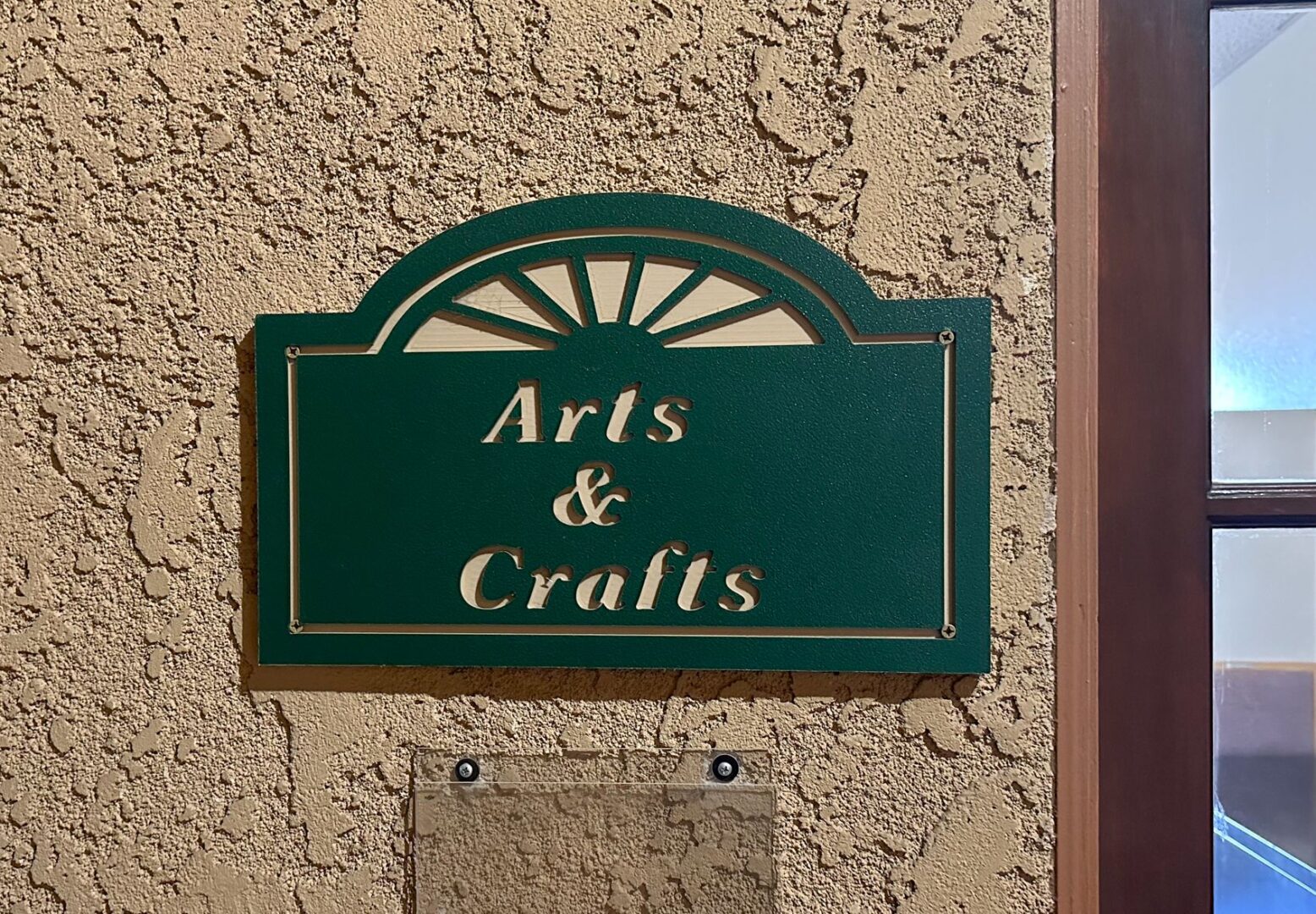 A sign that says arts and crafts on a wall.
