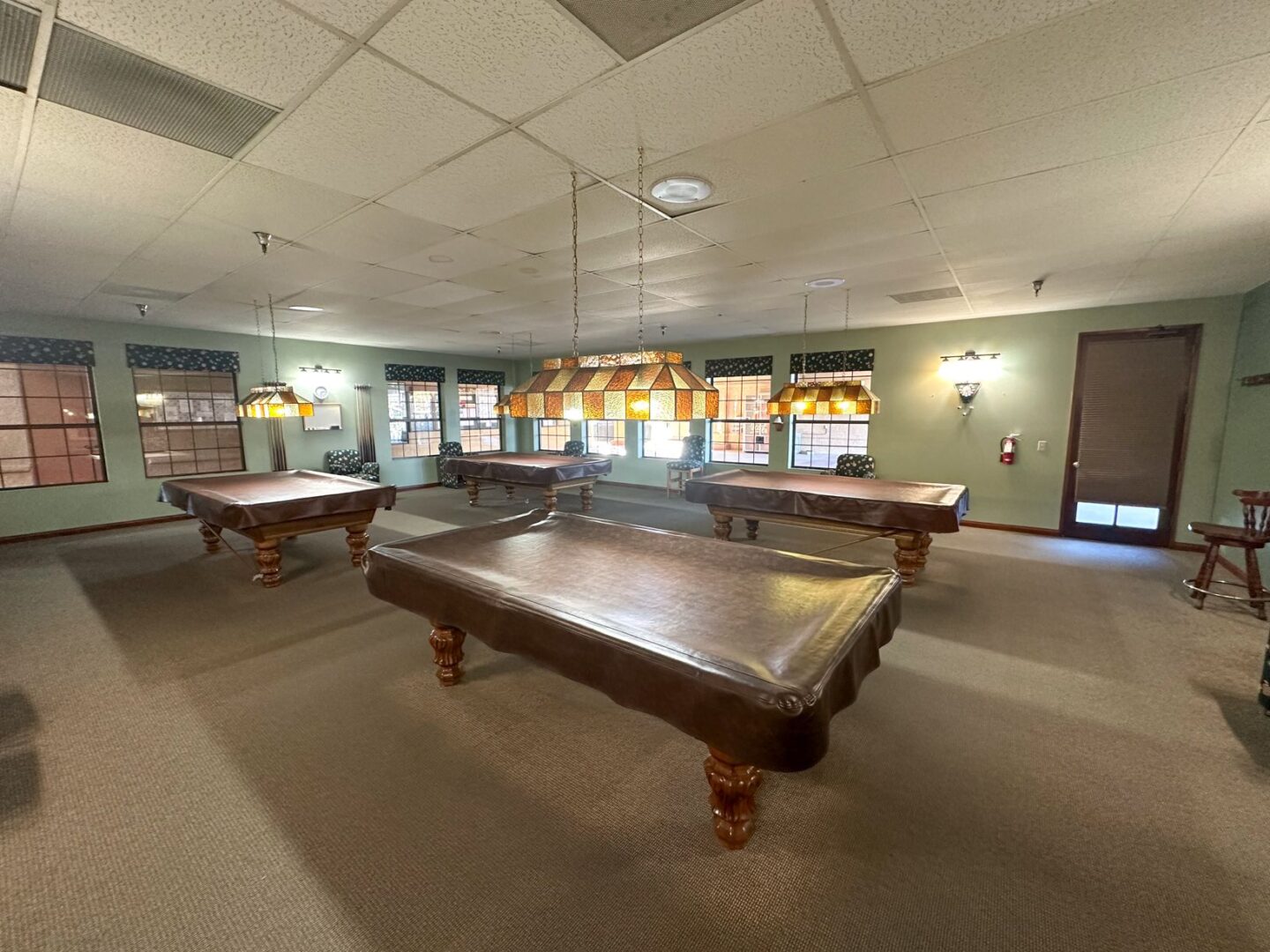 A room with a pool table and billiards.