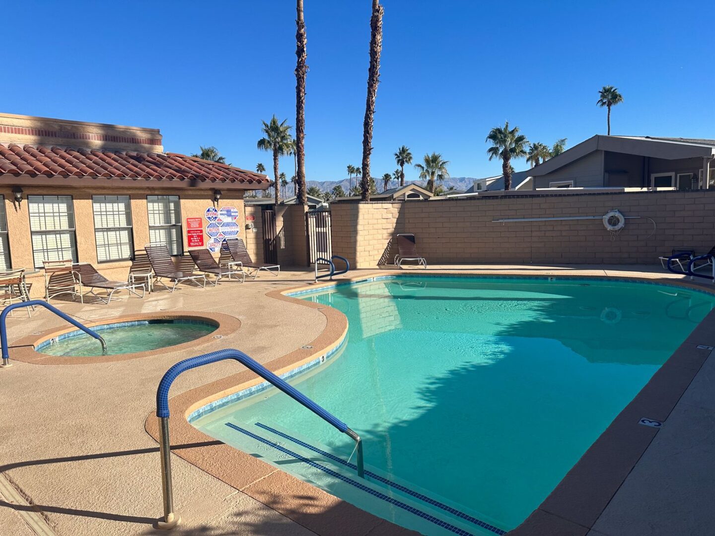 A swimming pool at an apartment complex in palm springs.